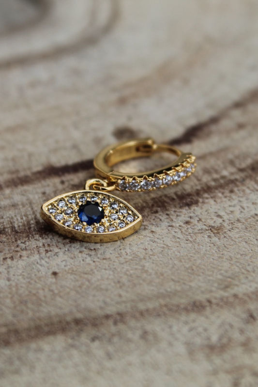 Golden earring stacking white stones blue eye